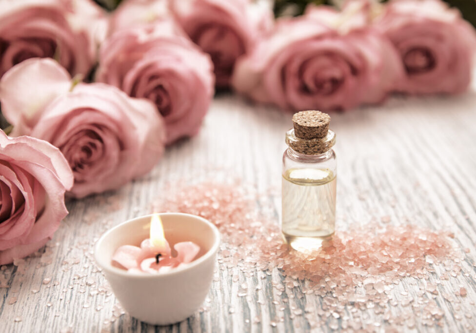 Spa theme with candles and flowers on wooden background