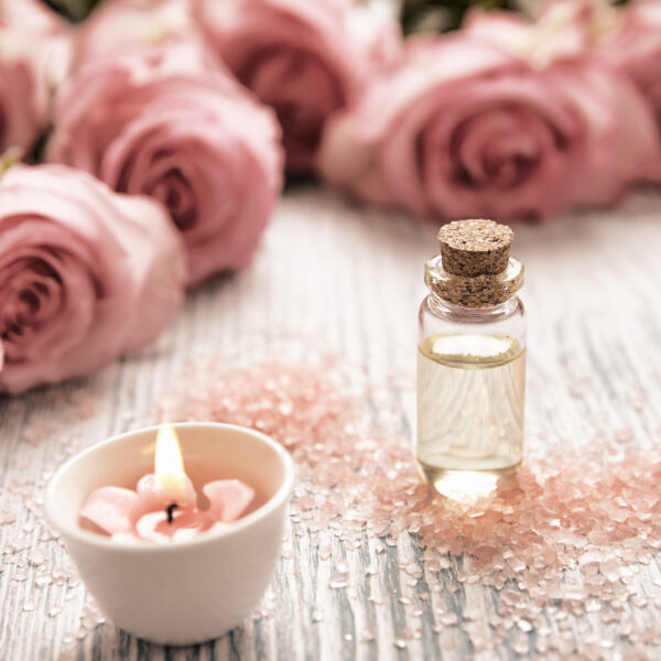 Spa theme with candles and flowers on wooden background